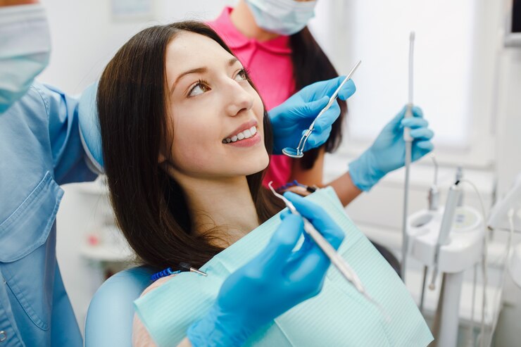 Young woman having a dental treatment at clinic<br />
